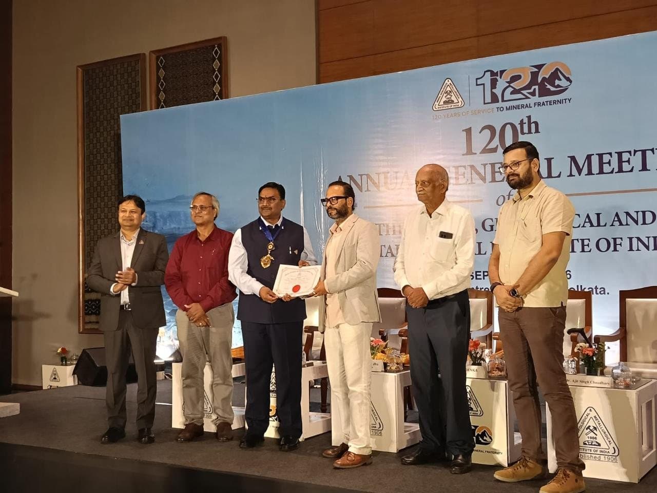 Prof. Manojit Ghosh receiving a certificate on stage at the MGMI 120th Annual General Meeting